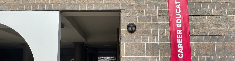 Brick storefront of the Career Education offices with sign