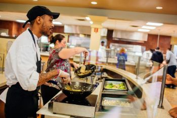 Servers assisting students at the dining hall at Arcadia