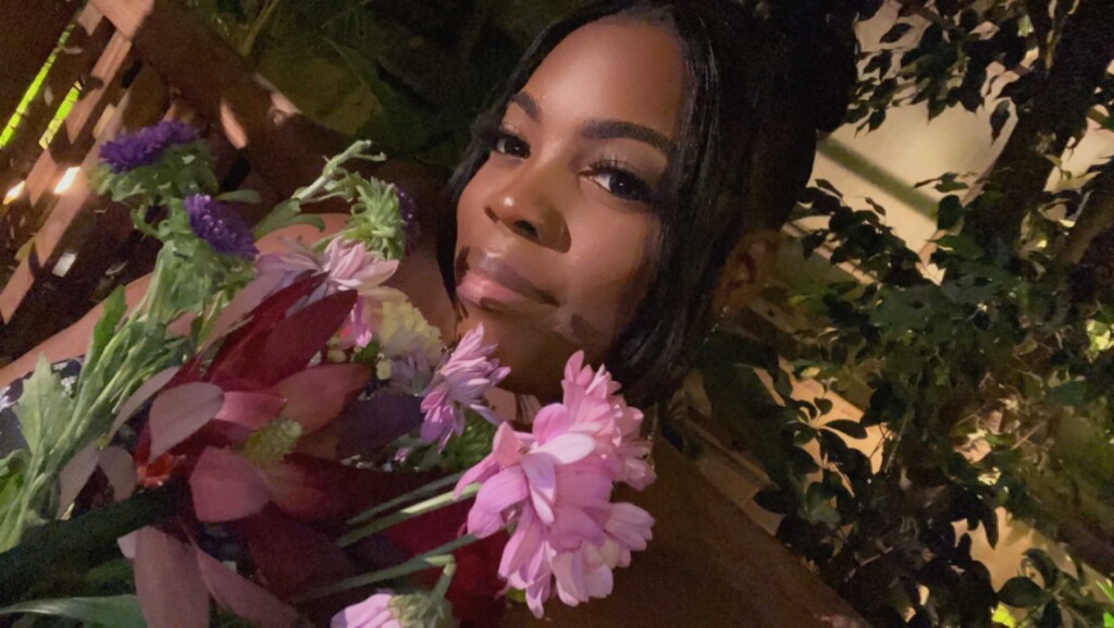 A photo of Roseanna holding flowers.