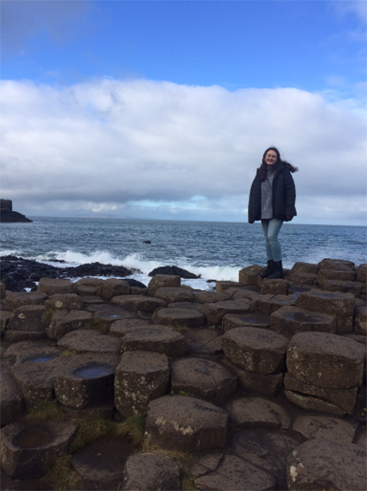 A student stands on the rocks of Giants' Causeway in Ireland