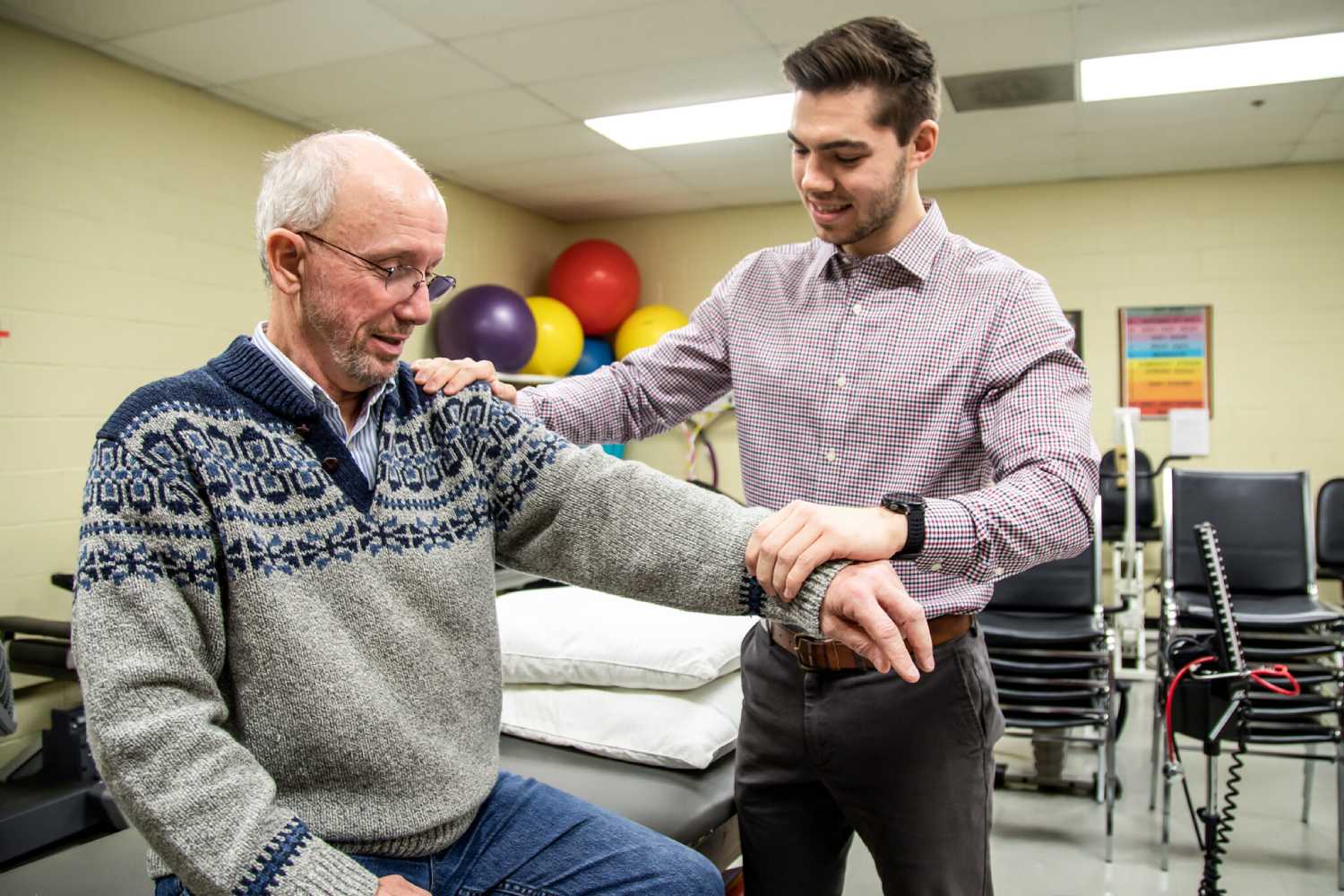 A physical therapy student helps a patient