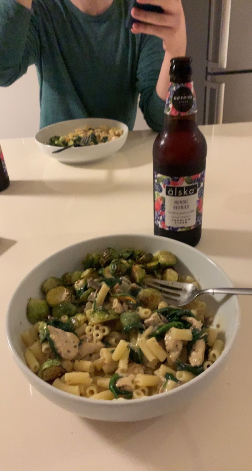 A meal of pasta with green vegetables and chicken