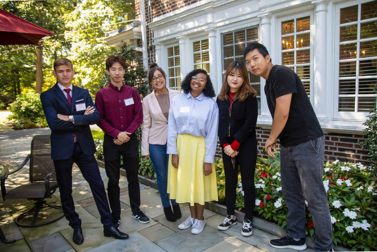 Six international students visiting the President's house.