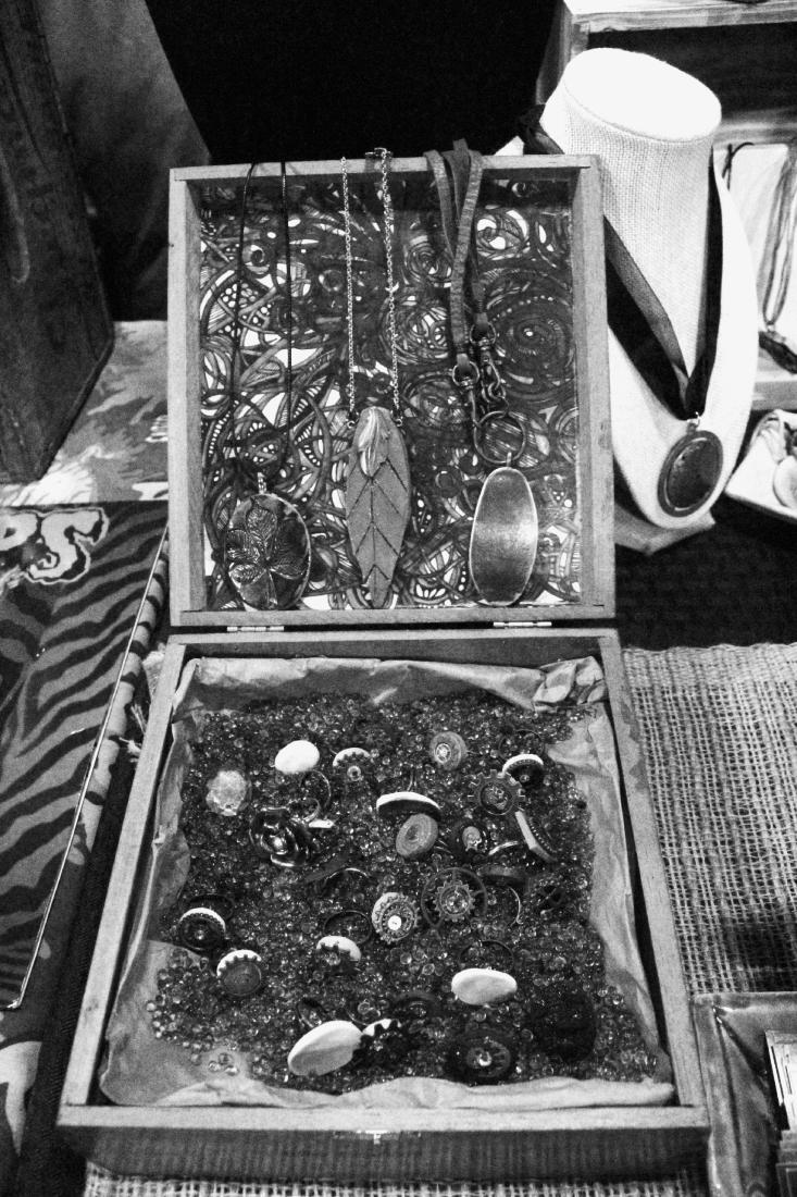A box filled with buttons and jewelry pieces.