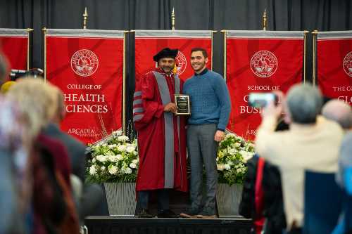 Michael Stemen Honors Convocation award recipient accepts award on stage.