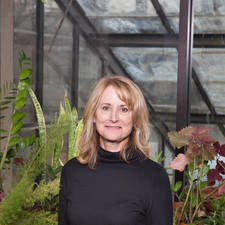 A headshot of Naomi Phillips in front of plants