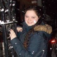 Brunette woman smiling in the snow.