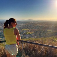 Alexis Shwartz facing towards a hillside expansive horizon view.