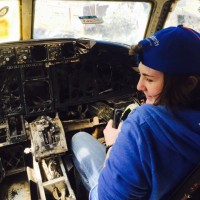 A student sits in a cockpit