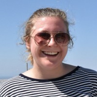 A headshot of a woman wearing aviator sunglasses