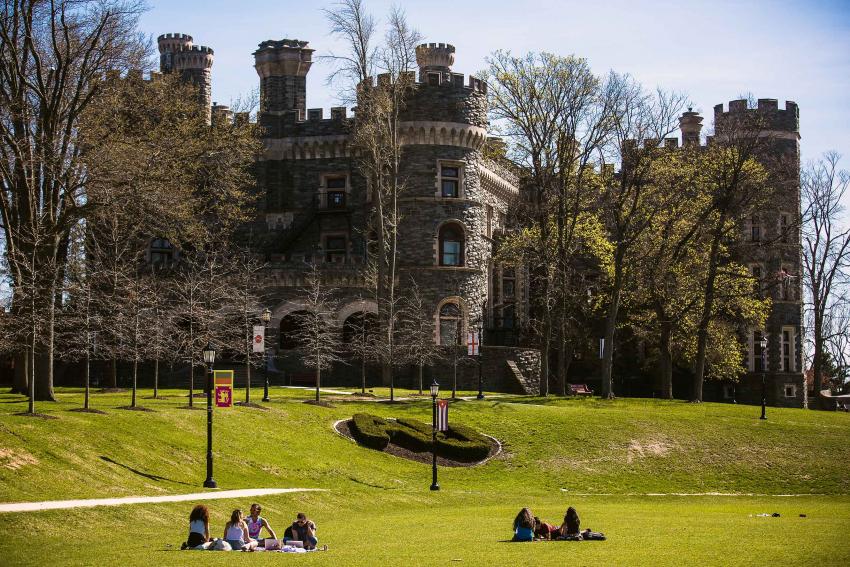 Arcadia Grey Towers Castle exterior with students gathered in groups on the lawn