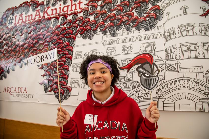 Student holds banners during Scarlet and Gray Days.