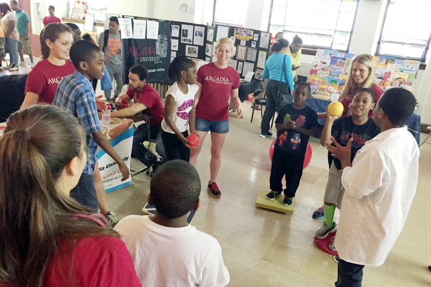 A group of Arcadia ambassadors playing catch with children.