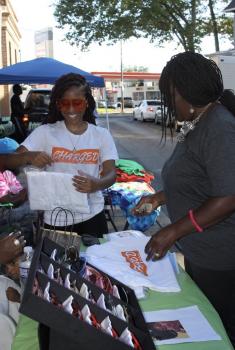 A person selling items from a booth.