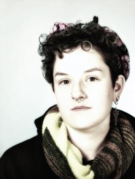 Black and white portrait of Jesse with short curly hair and scarf by Fran Eber