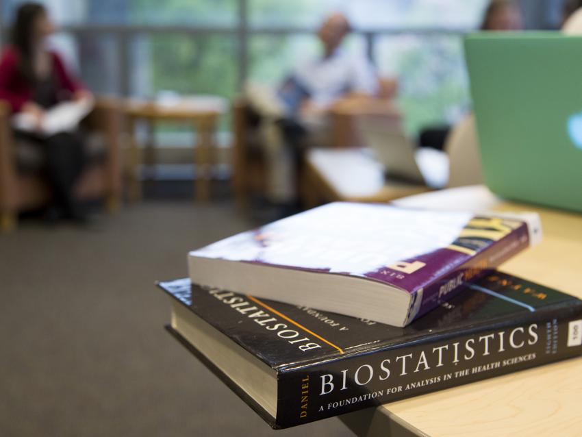 A stack of Public Health books on a table