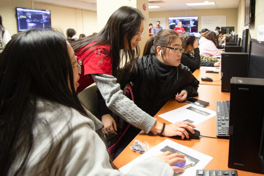 Dr. Jia helping students in the computer lab.