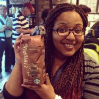 Naomi Waltengus holding a bag of Starbucks coffee