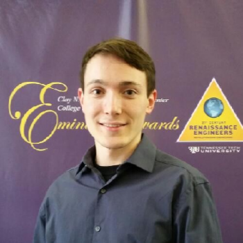 A student standing in front of a poster