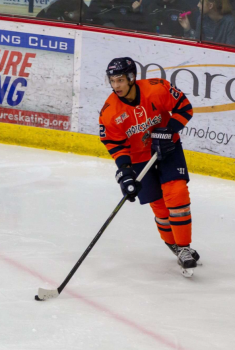 Student Connor Bowey playing men's ice hockey.