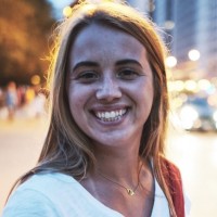 A portrait of a woman with city lights behind her