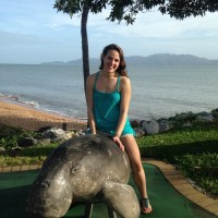 A photo of a woman sitting on a pile of stones