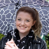 A portrait of Audrey Eggleston / a woman holding an umbrella