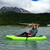 A girl on a kayak in the water.