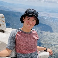 Portrait of Jaden Lee smiling on a hilltop.