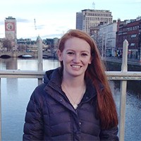 Jessica L. smiling in front of a river.