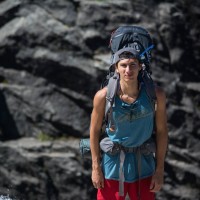 Julian Callin with hiking gear on a mountain.
