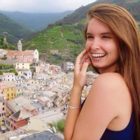 A photo of Nicole DiCenso standing over a city