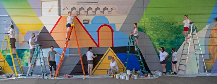 Ten people working on a big art project.