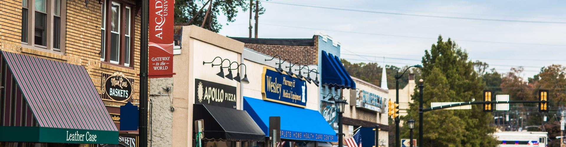 A photo of downtown Glenside that includes Leather Case, Apollo Pizza, Main Line Baskets, and Wesley Pharmacy