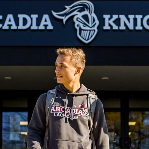 Three male students walk in front of Arcadia Kuch Center