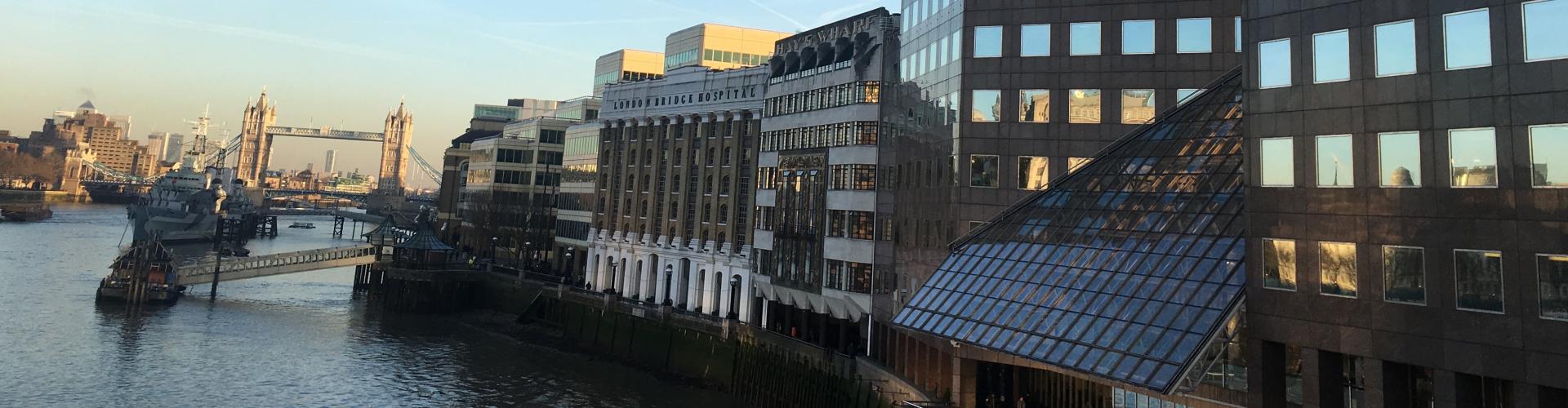 View of buildings and London Tower Bridge from River Thames.