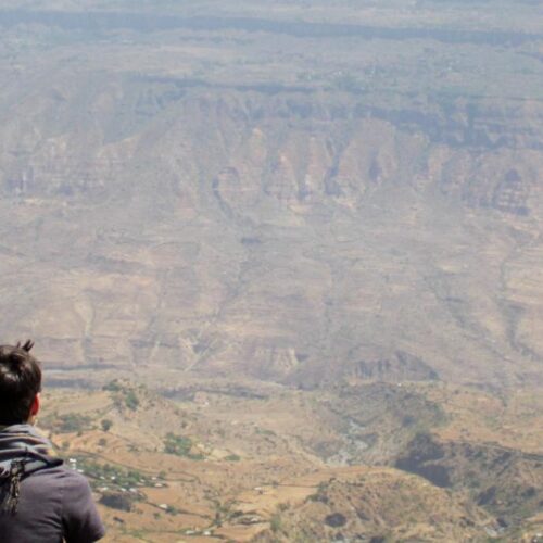 Two people looking over a canyon