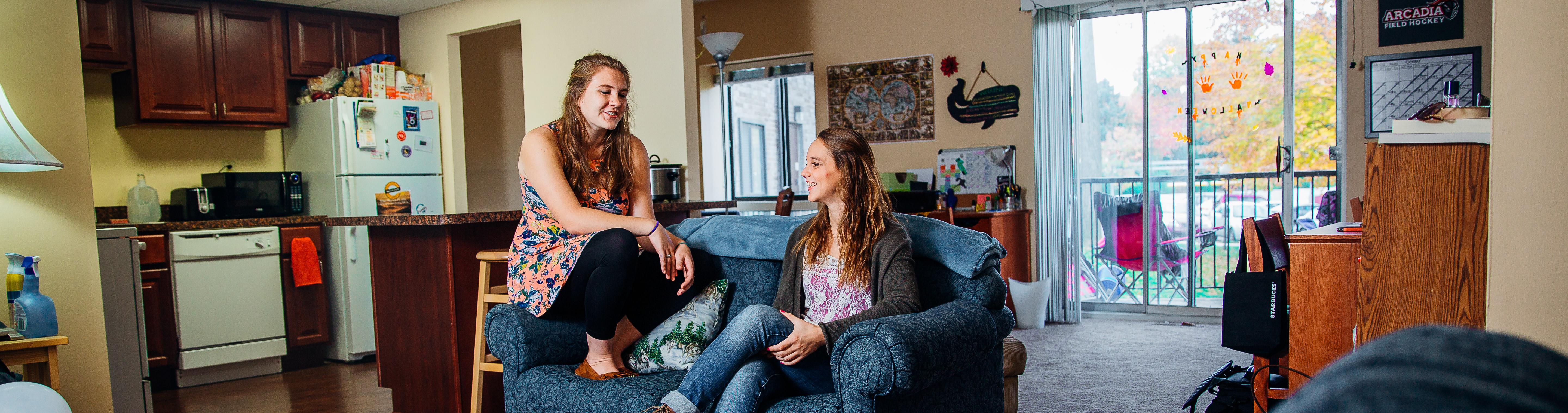 Two students talking to each other in an Oak Summit apartment.