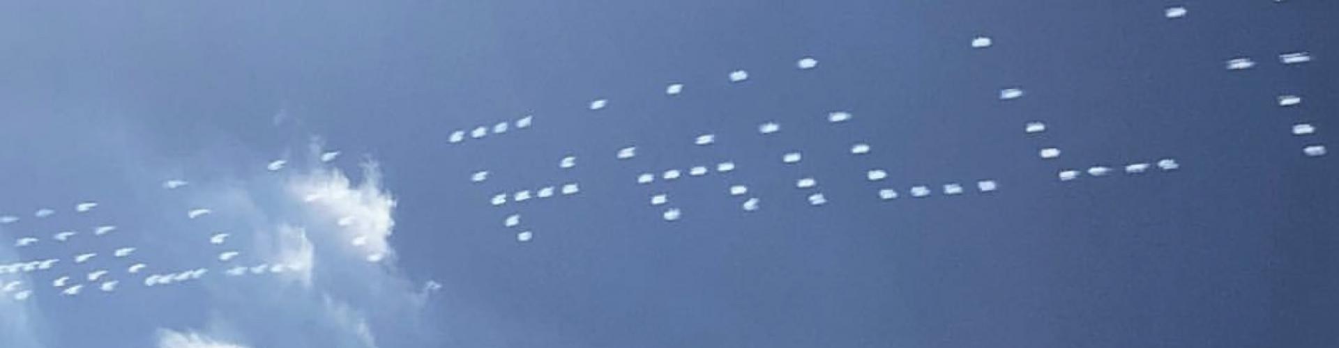 A light show in the sky where the dots spell a word
