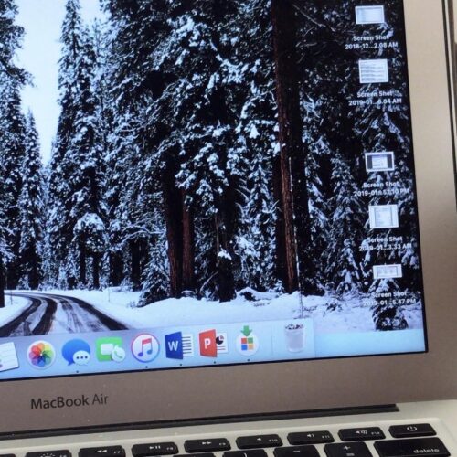 An open laptop with a Starbucks coffee cup next to it