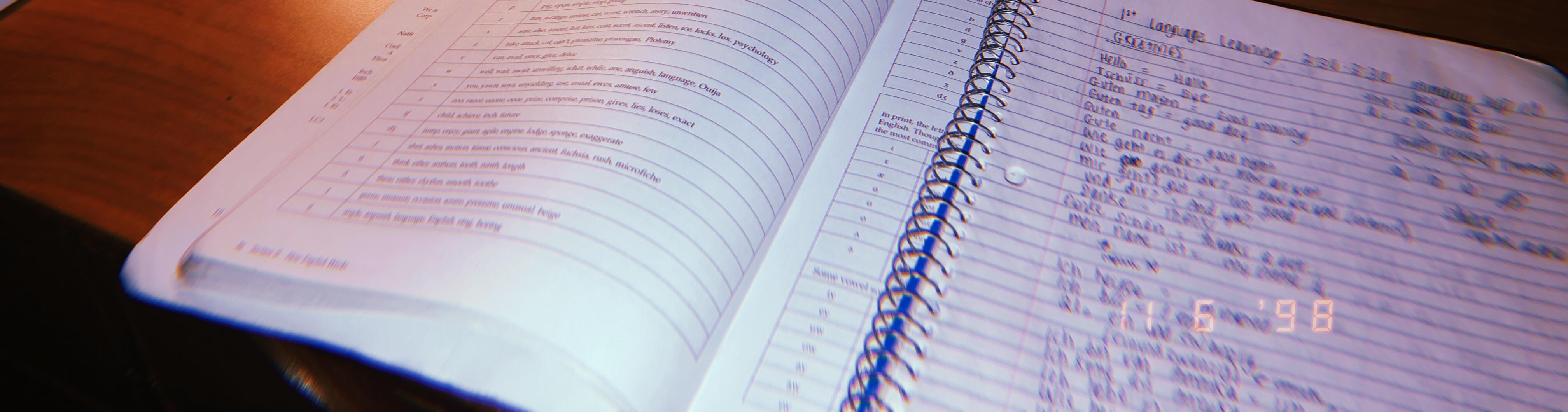 A blurry photo of a notebook on a textbook.