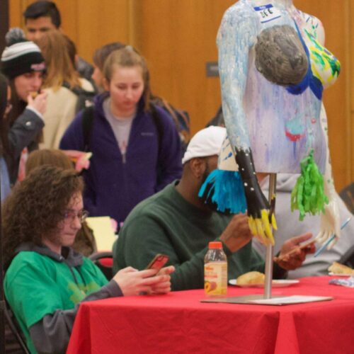 A photo of art on display in the Great Room. Specific artwork in this photo display pride in LGBTQ.