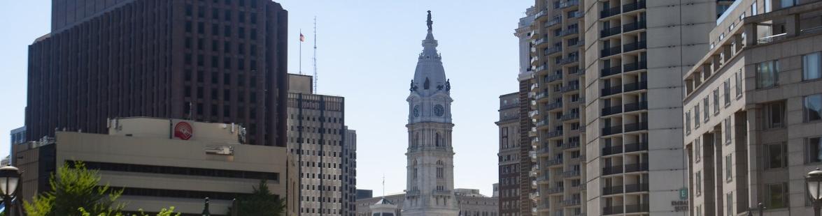 A panoramic view of Philadelphia with a large clock tower at the center.