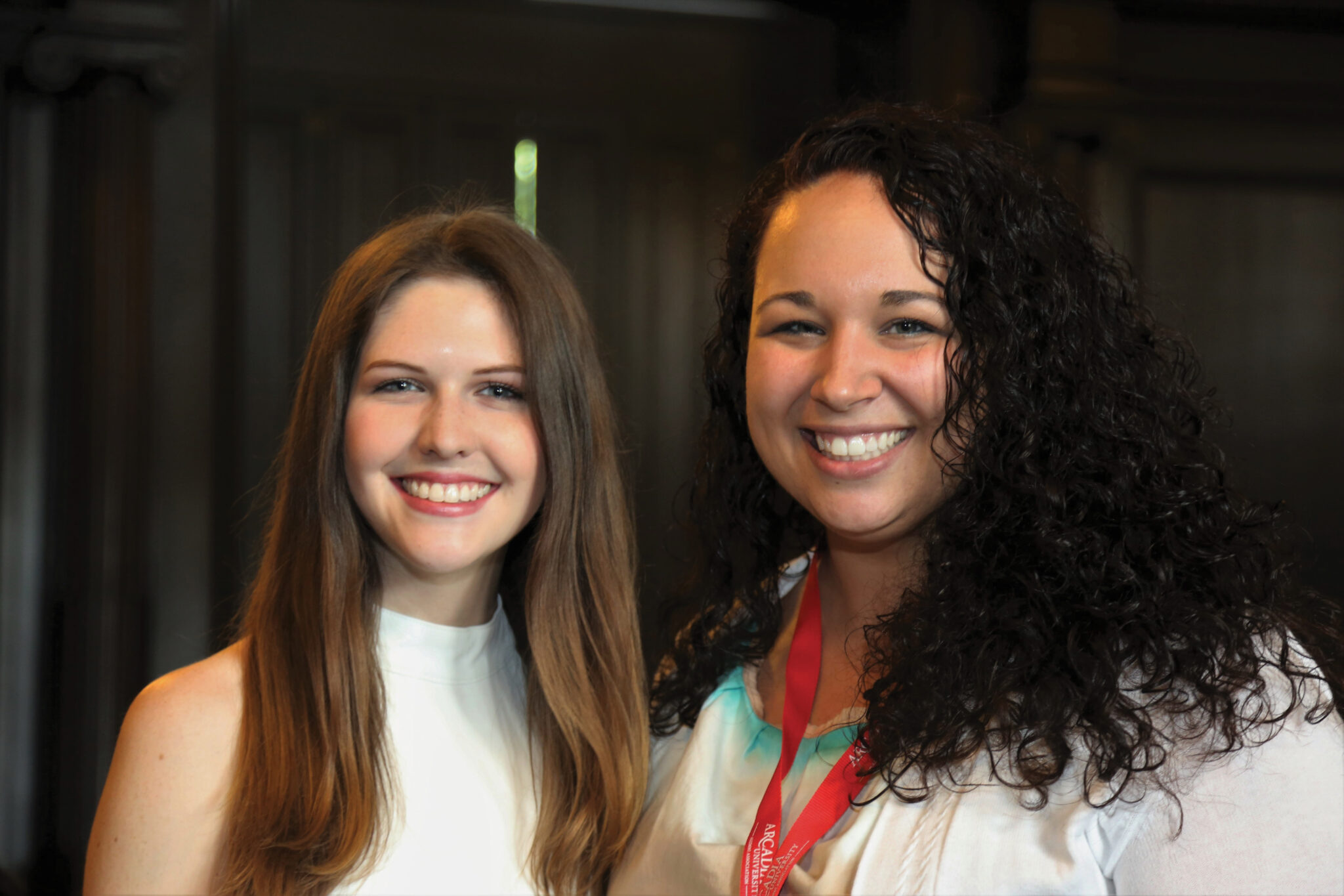 Two alumni students posing together