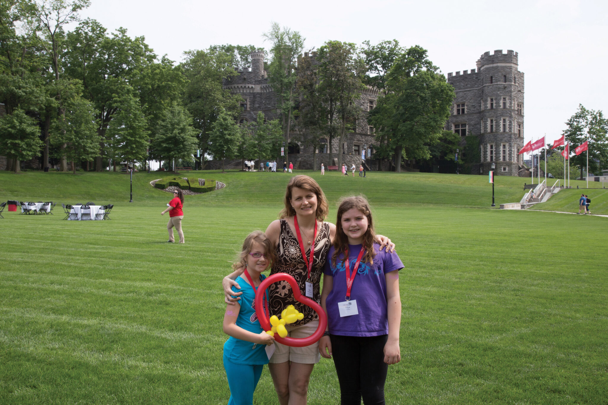 an alumni student posing with her family on Haber Green