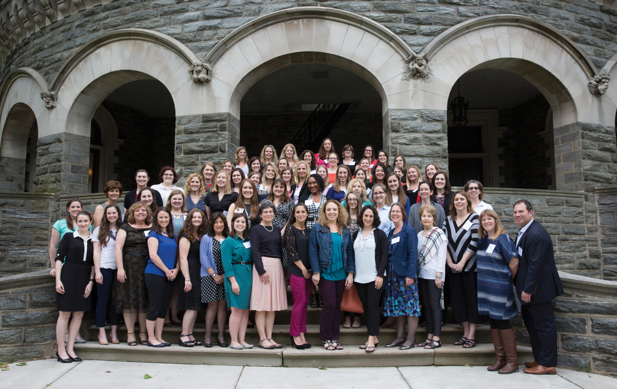 A large group of students posing together on Grey Towers exterior staircase