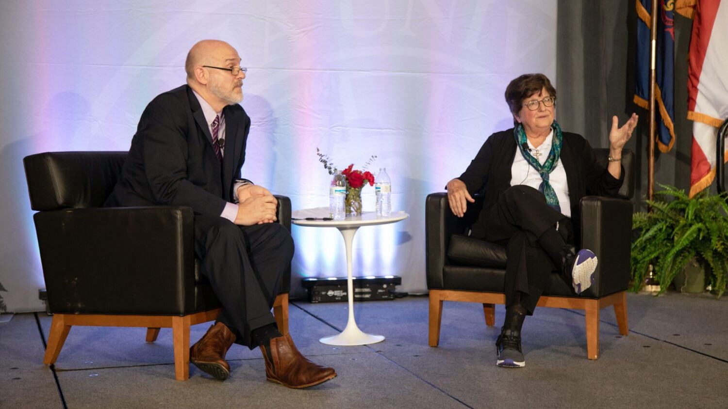 Sister Helen Prejean gives a speech from a stage