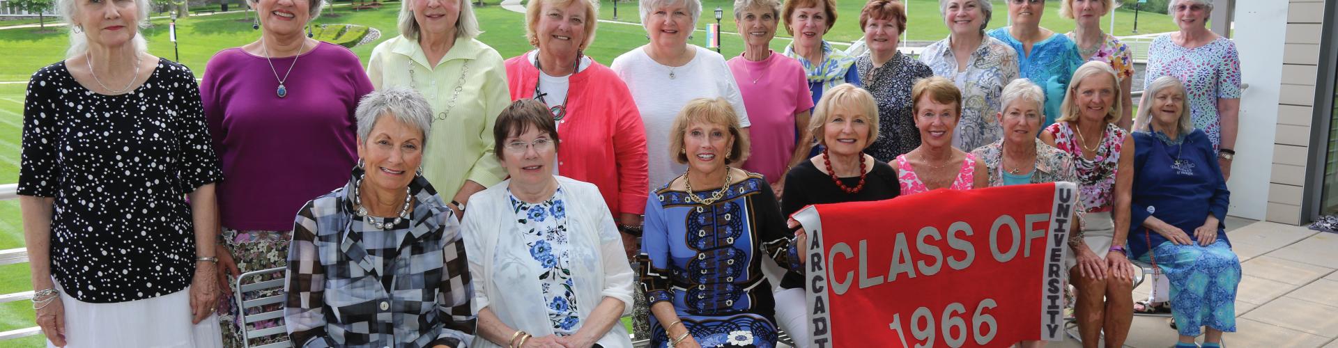 Group of class of 1966 women in front of Haber Green.