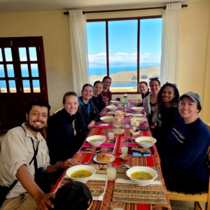 The group sits down after a long hike to a traditional meal including quinoa soap and trout