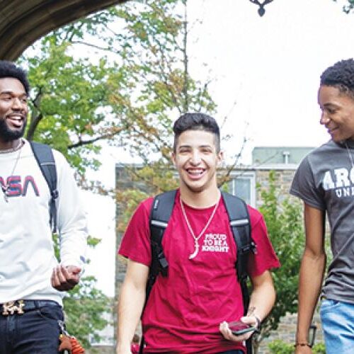 Six students walking and talking together.